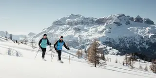 Snow shoeing in Alta Badia, Sella Group in the background
